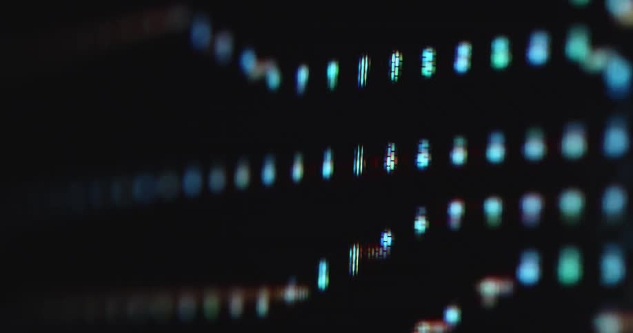 Dark computer or pc screen with RGB pixels displays animation of data lines or cables on a hardware mainboard with diodes as visualized data is moving towards a processor or chip gathering information through computer science
