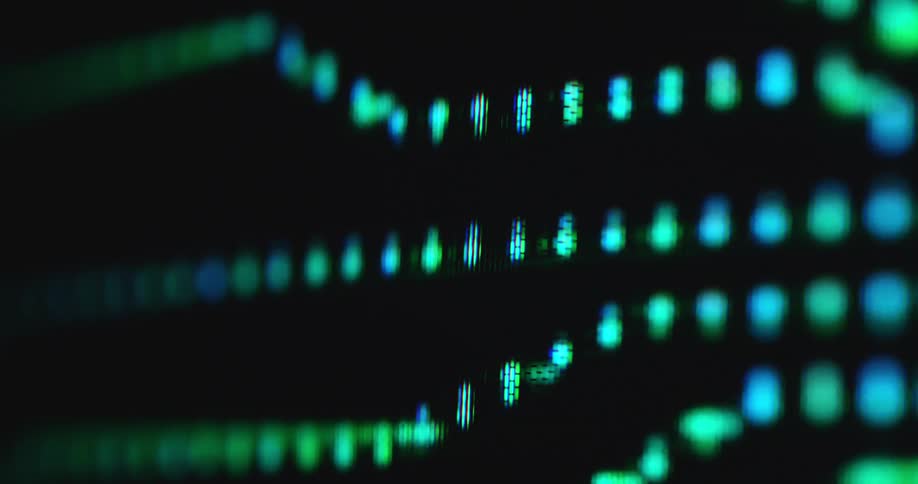 Glowing neon green light dots flowing through data lines of an animated computer chipset with a processor on the printed circuit board or pc motherboard while digital information is transferred displayed on a pixelated RGB PC screen