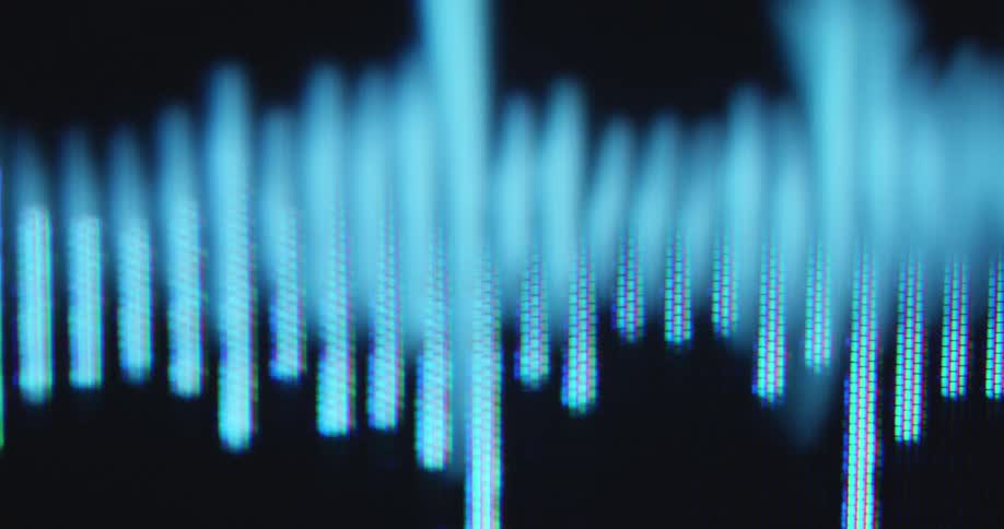 Dynamic handheld macro close up with shaky camera movement of white 2D sound wave bar animation is jumping on the screen as symbol for the recording of a podcast audio book or music track