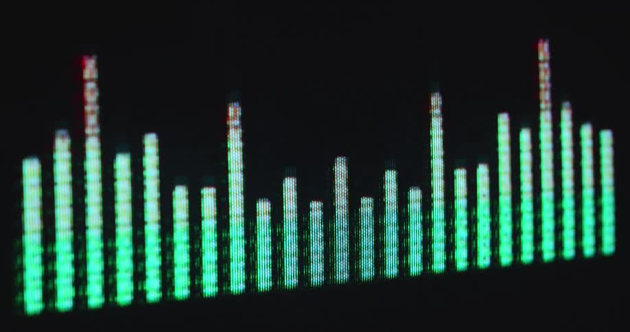 Sound bars of a neon green equalizer or EQ display with visible RGB pixels rise and fall as the music visualization plays a song or beat on the vintage Hi-Fi stereo system