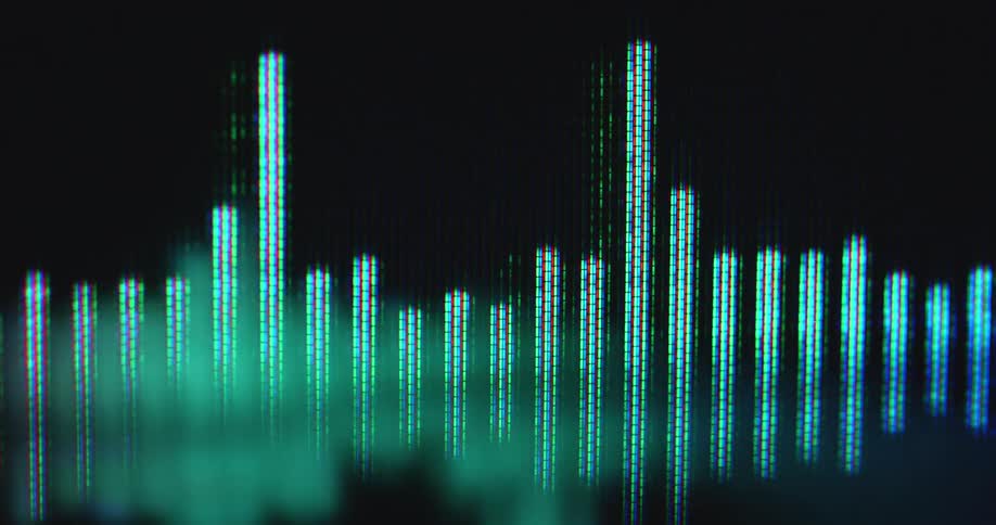 Animation footage of a colorful equalizer with blue and green sound bars as audio visualization and symbol for loudness or sound design with dynamic film camera movement on a dark computer screen with black background