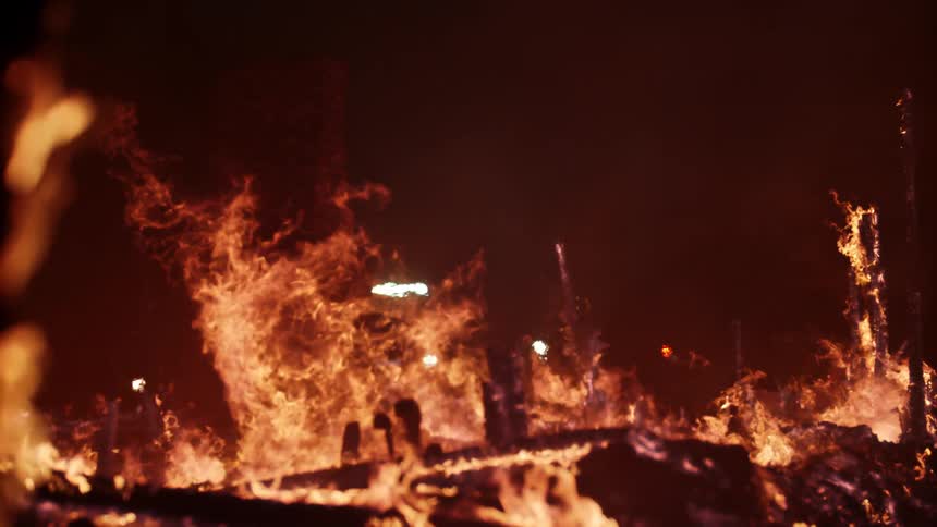 A firetruck is outside the burning home
