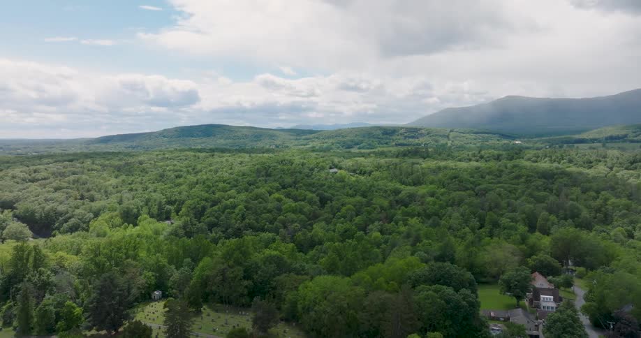 Dappled light filters onto the forest canopy covering the foothills of the Catskill mountains