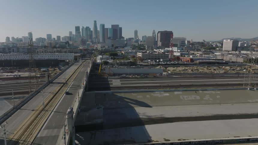 Cars are driving on a bridge towards  downtown Los Angeles