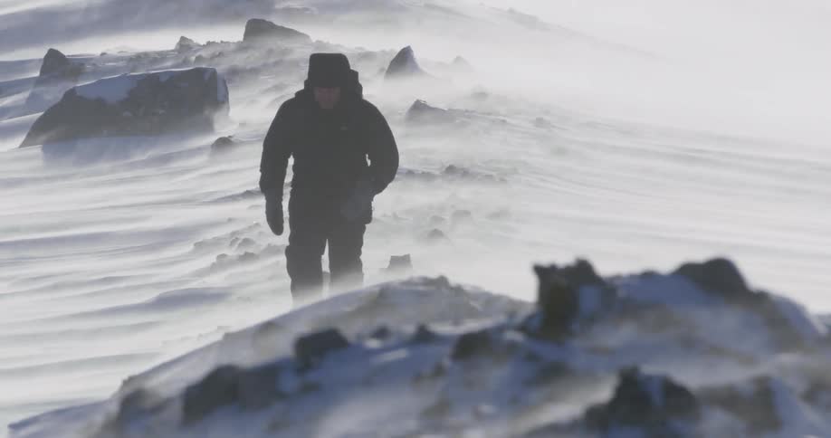 Wind is blowing very heavy as this man hikes