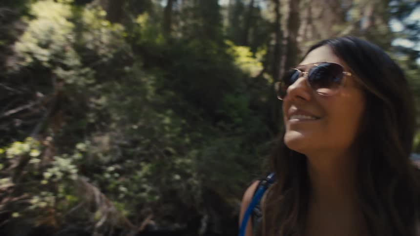 Woman in sunglasses on a forest trail