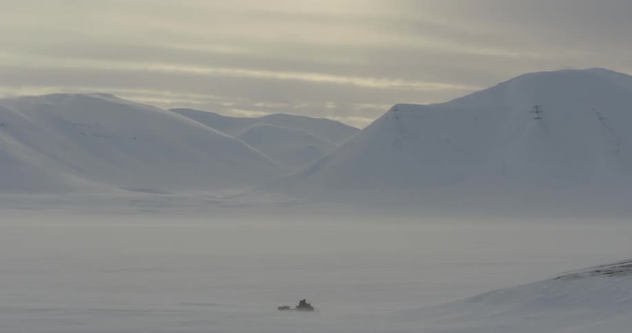 A view of snow covered hills with the sky in the background