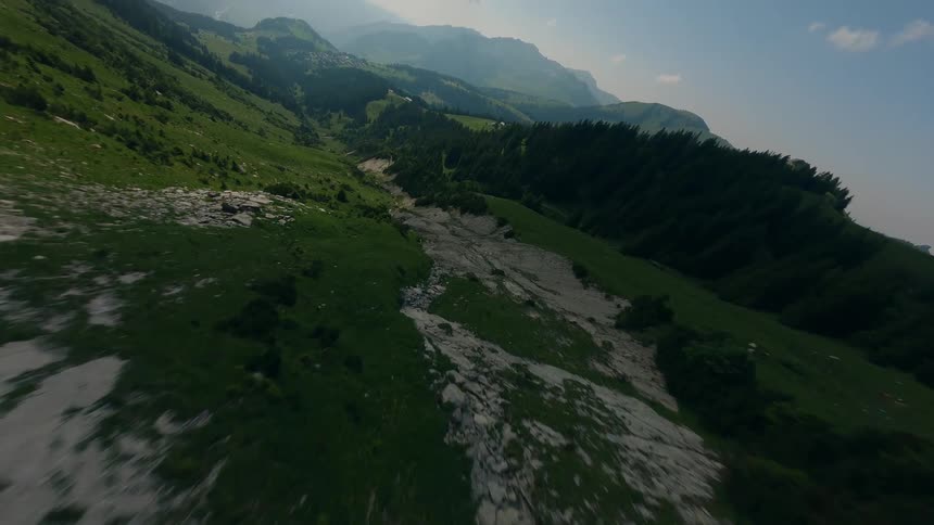 Drone Clip of Rocky Mountainous Slopes with Greenish Conifers