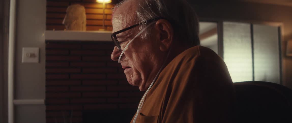 A man is talking and looking at a brochure