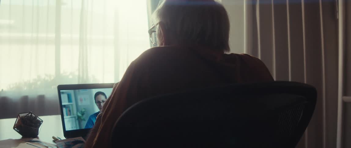 Elderly man in a teleconsultation with a nurse via laptop