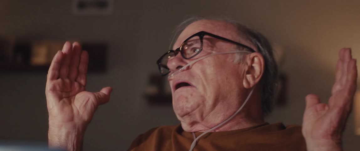 The man throws up his hands while talking