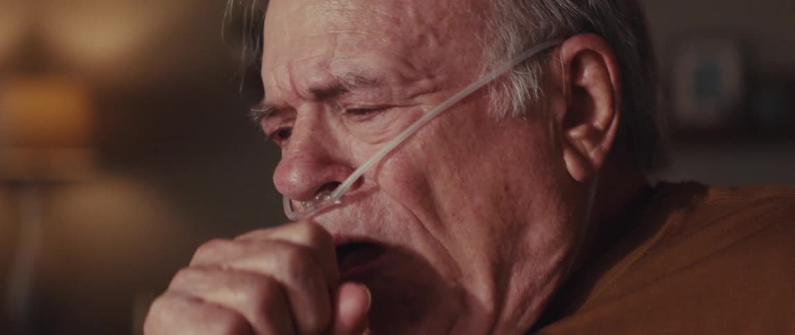 Elderly man coughing