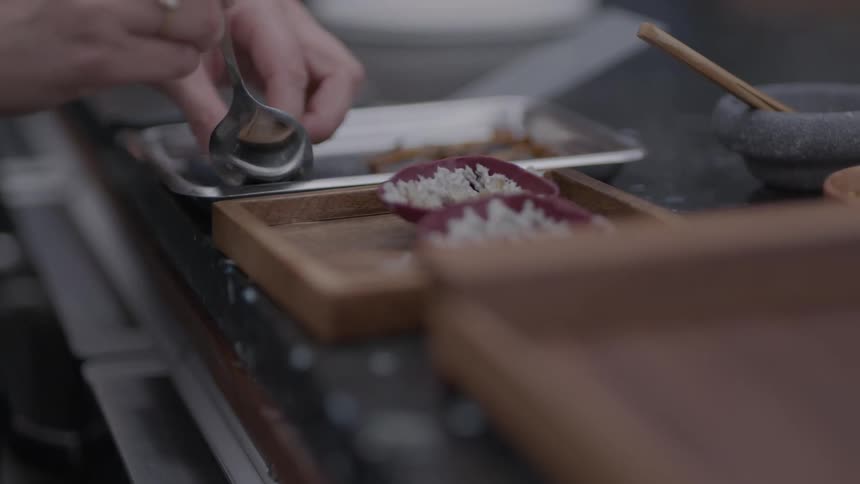 The chef carefully plates the food