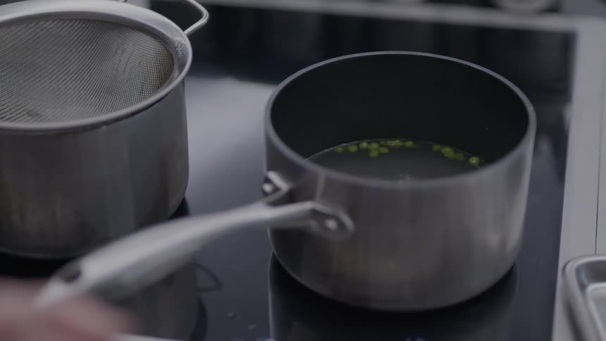 The liquid in the pot begins boiling