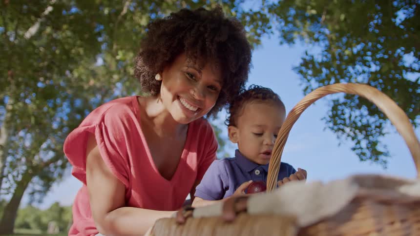 A mother and son are at a picnic