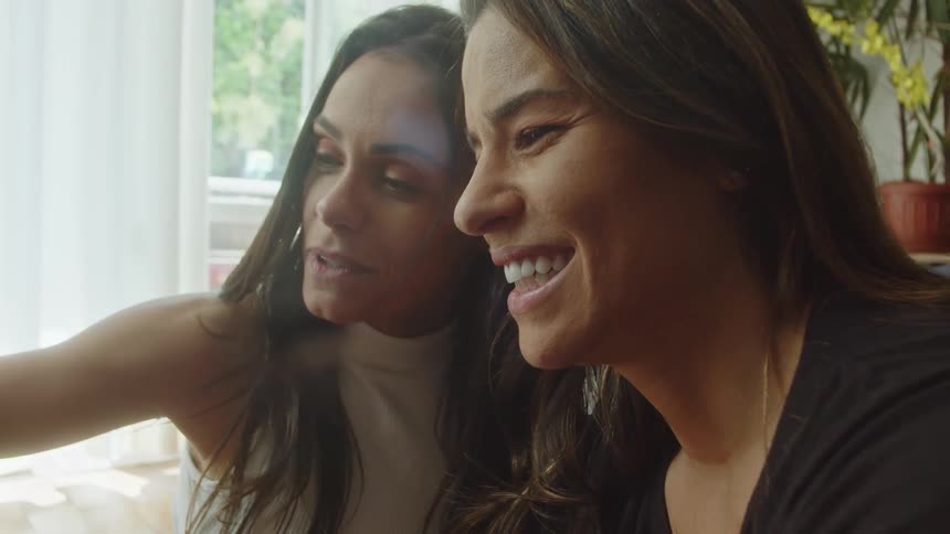 Two women smile and talk