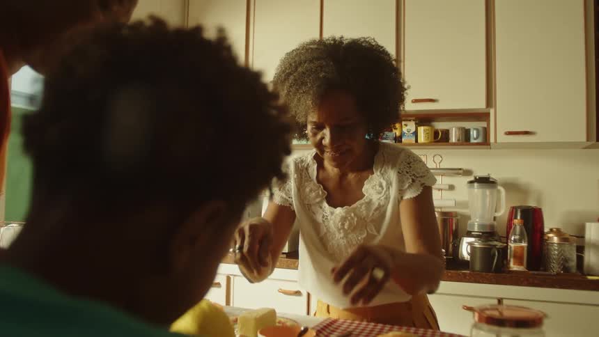 Boy with mother and grandmother in a kitchen