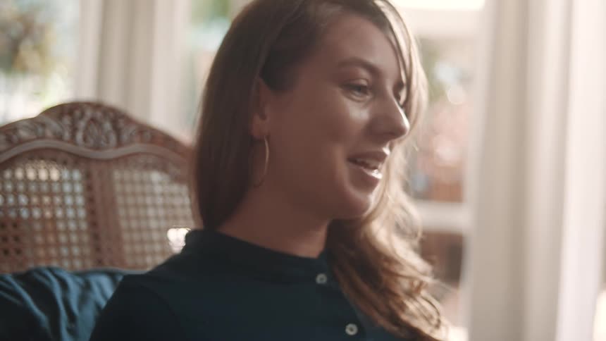 The sitting woman is talking and smiling