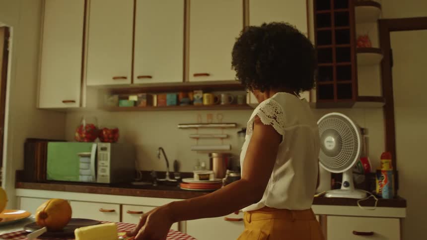 Woman serving food in a cozy kitchen setting
