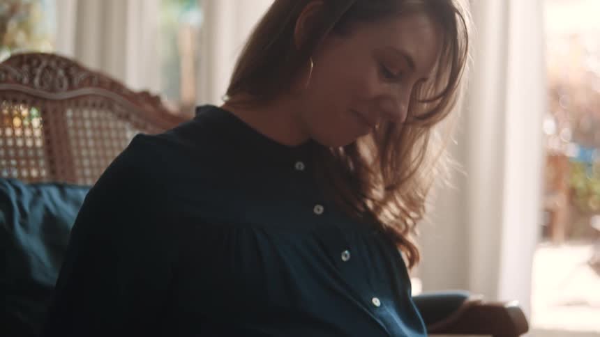 A woman is holding her pregnant stomach