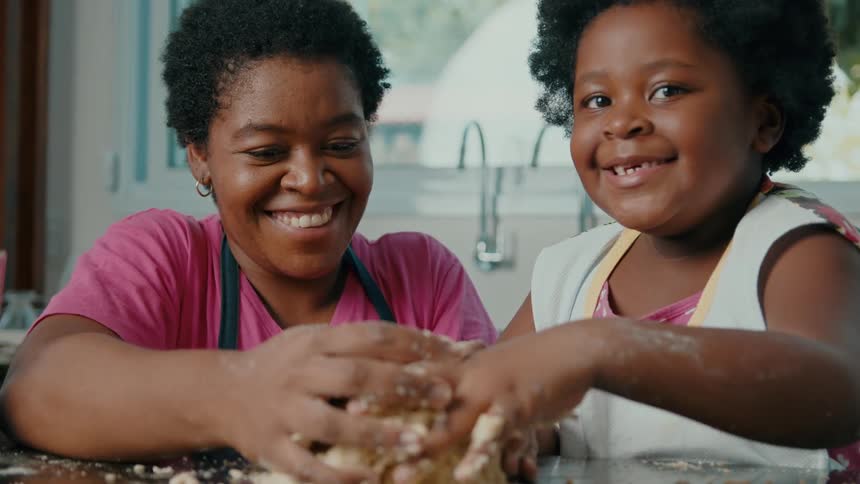 Mother and daughter cooking together