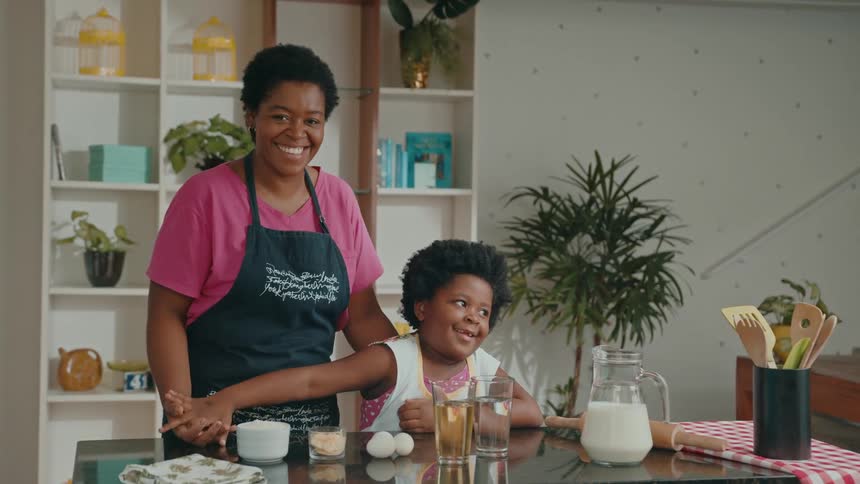 Woman and child preparing to bake together in a kitchen