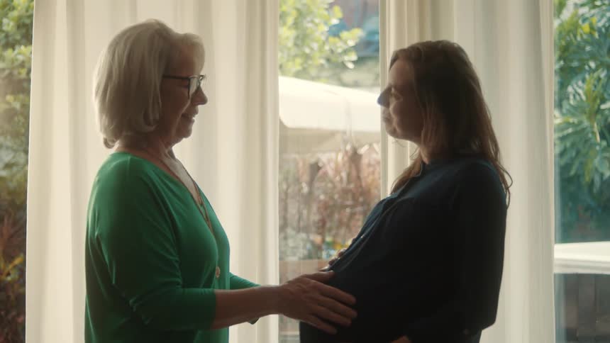 Lady interacting with a pregnant woman