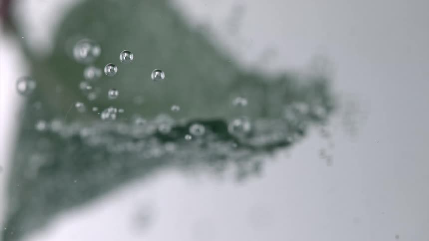 Transparent liquid with droplets in abstract motion