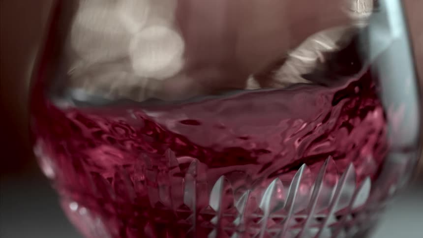 Red wine swirling in a stemless elegant wine glass