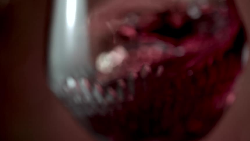 Red wine flowing inside a glass cup