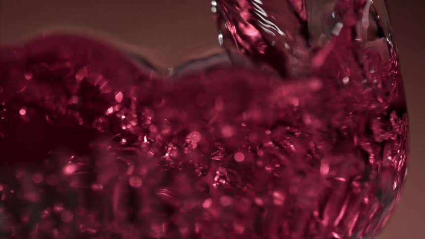 Wine is being poured into the glass