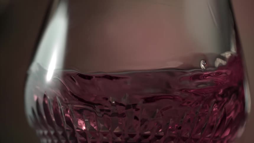 Red wine swirling in an elegant wine glass