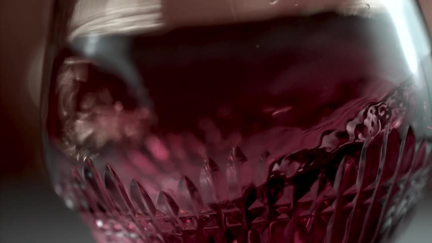 Reddish drink shaken in a glass bottle