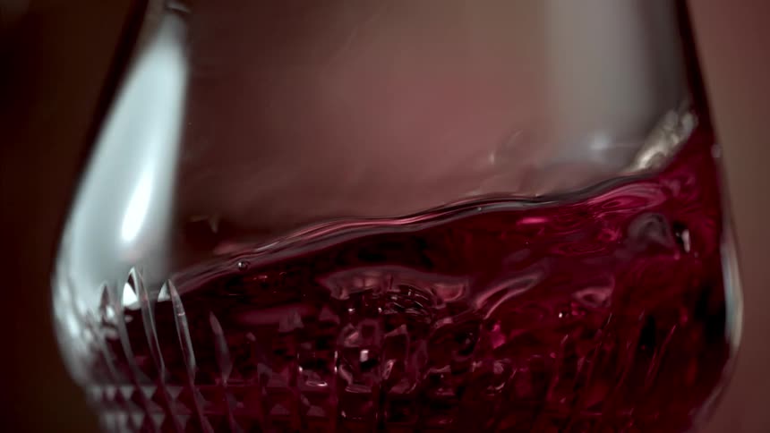 Close up of red wine swirling in a fancy glass
