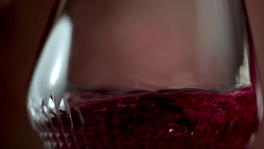 Red wine swirling in a fancy clear wine glass