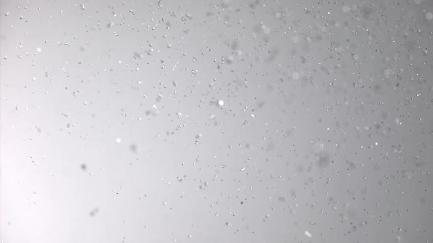 Several drops of clear water falling in an environment with a white background