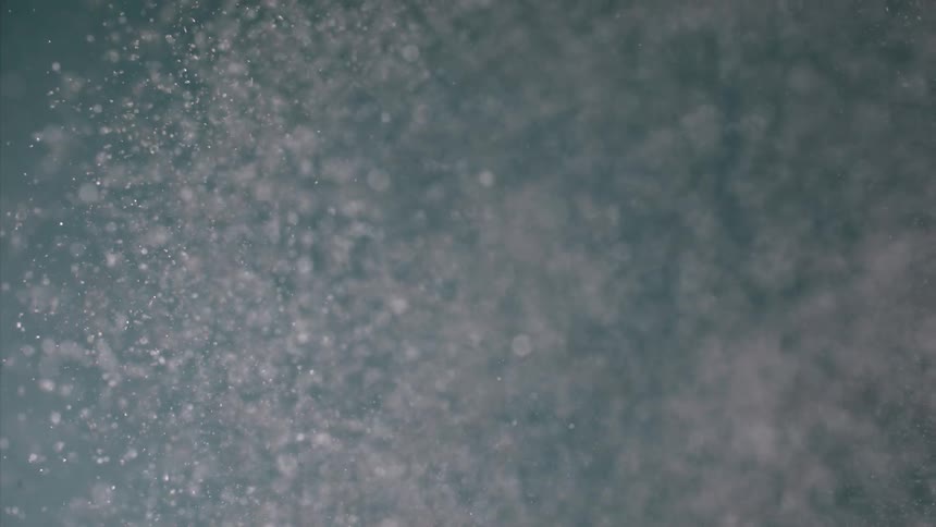 Several particles of small white bubbles advancing over an environment with a blue background