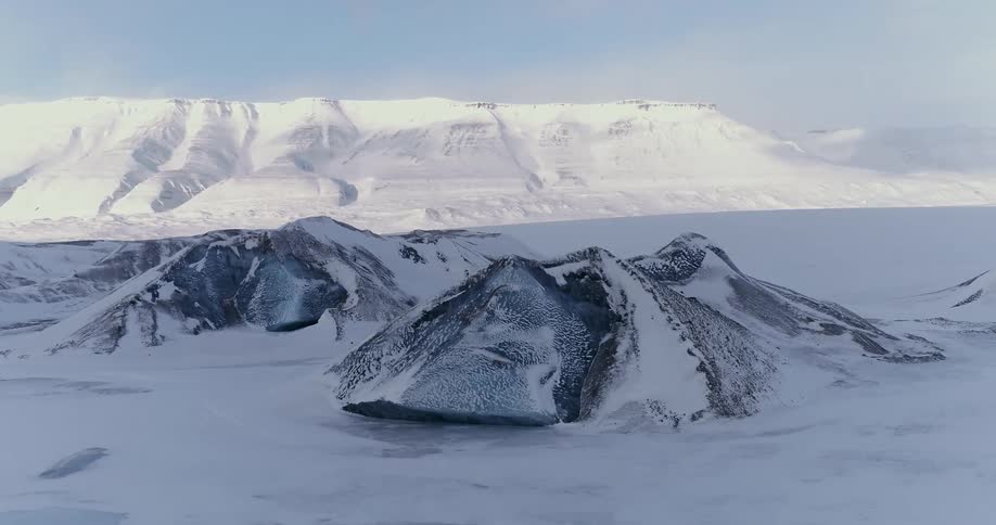 The sun shines on a frozen arctic landscape