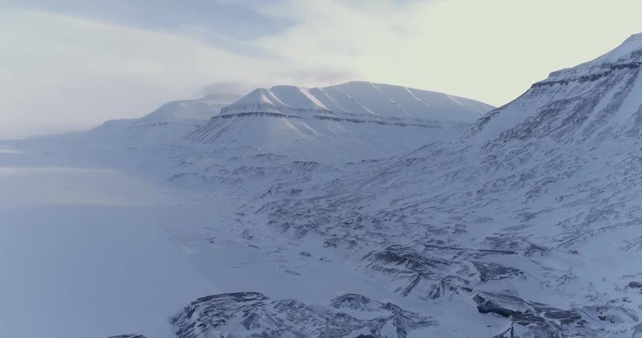 Snow covered mountain wilderness on cloudy day