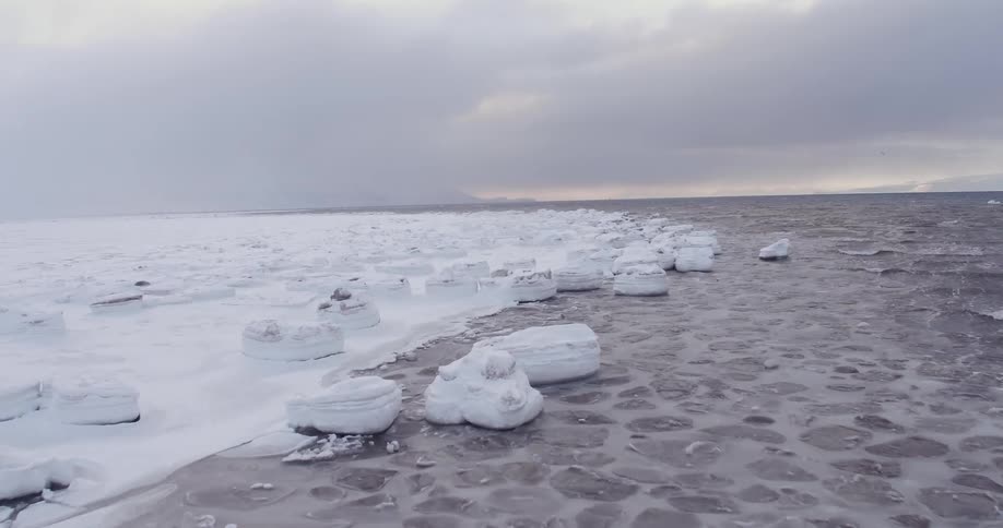The water is surrounded by ice and snow