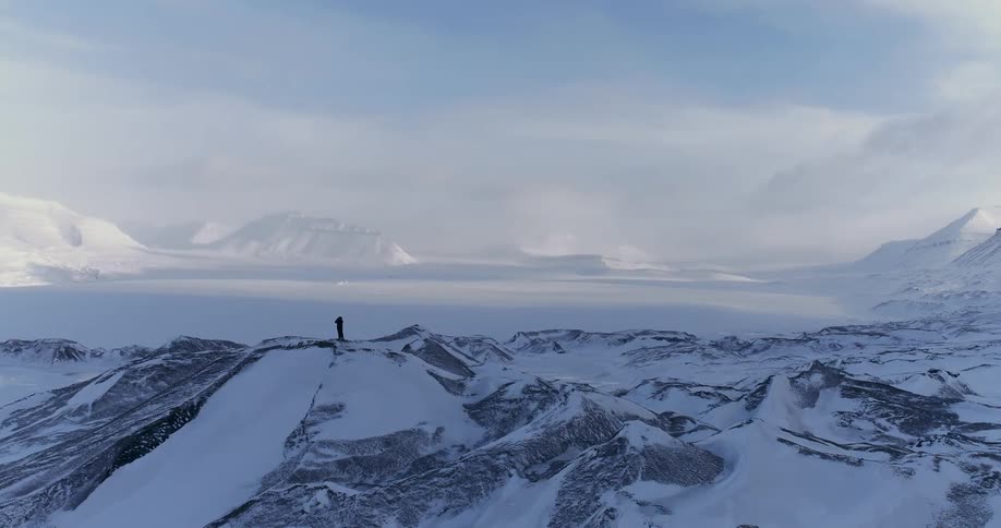 A man stands on the mountains ahead