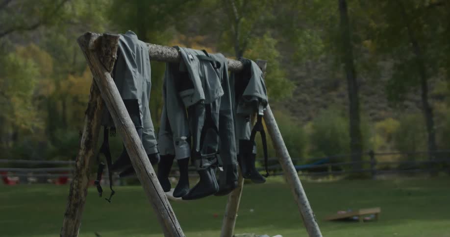 Overalls are hanging on the rack outside
