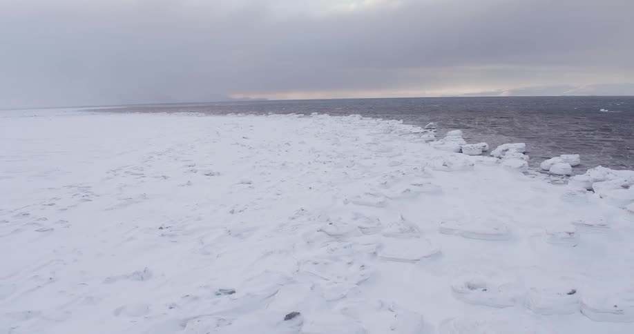 Cold ocean waters meeting up to snow covered arctic ground