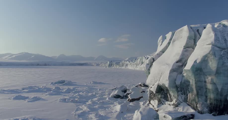 The long field leads to a huge ice mountain