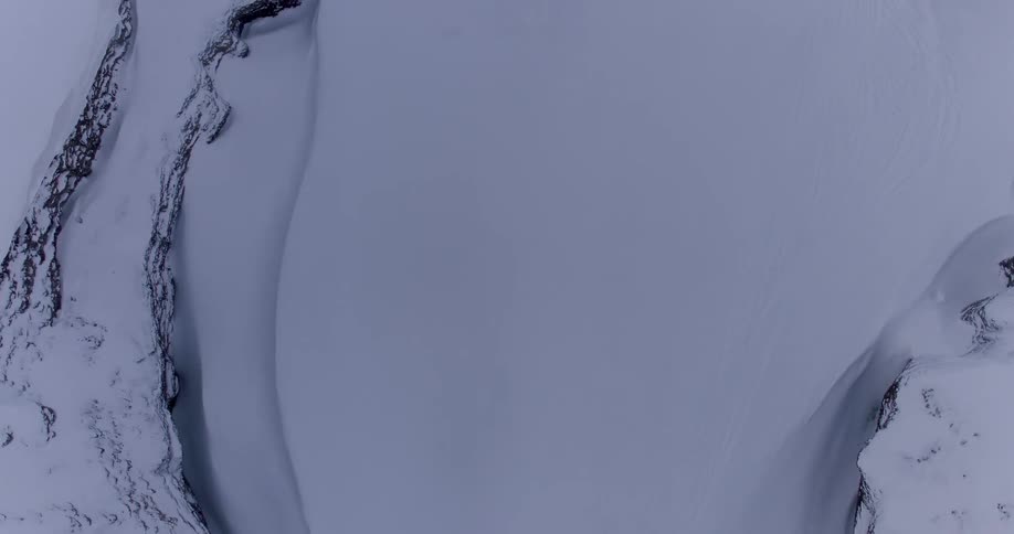An overhead view of a mountains or hills covered in snow