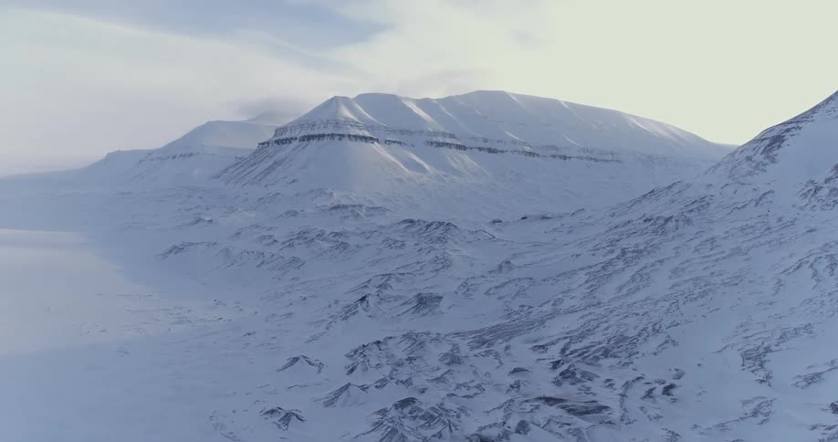 The field and mountain is covered with snow
