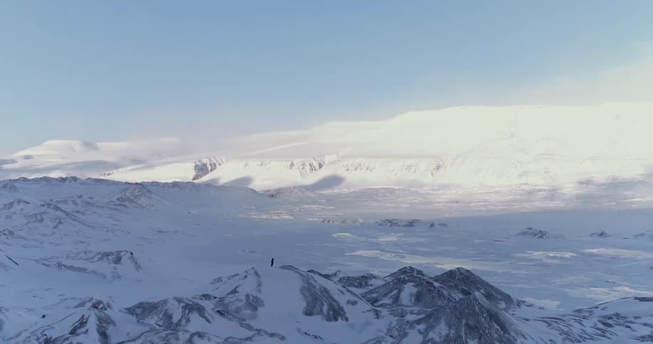 A person on top of a snowy mountain