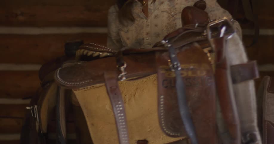 Woman handling a leather horse seat
