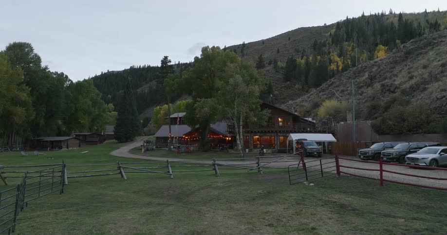 Resort of a large wooden house at the foot of a mountain surrounded by forest