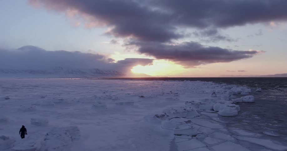 View of a snowy landscape next to a body of water